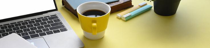 mug of coffee, laptop and stationery