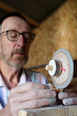 Fred Curtis grinding a flint nodule using a wooden wheel with quartzite grit as an abrasive. Experimental Archaeology