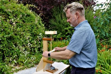 Joe Fenwick, experimental archaeological research, drilling a stone (flint) using a hollow drill-bit of oak with an abrasive paste (quartzite grit)