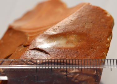 A facet ground onto a flint nodule using a wooden wheel (alternating motion) with a quartzite grit abrasive. Experimental archaeology. 