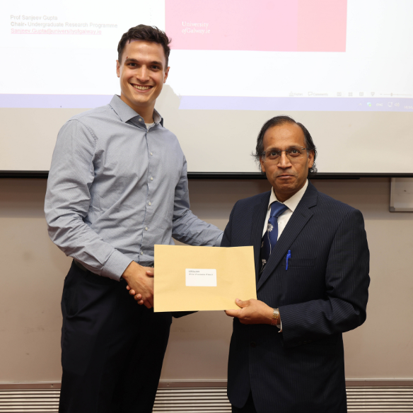 Male student receiving her award from academic