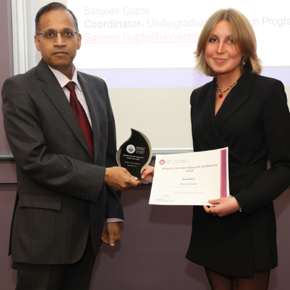 female student receiving her award from academic
