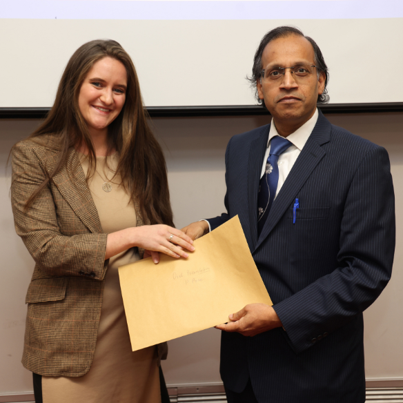 female student receiving her award from academic