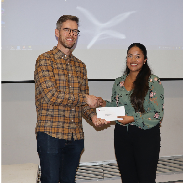 female student receiving her award from academic