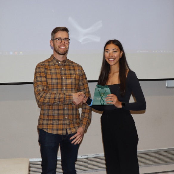 female student receiving her award from academic