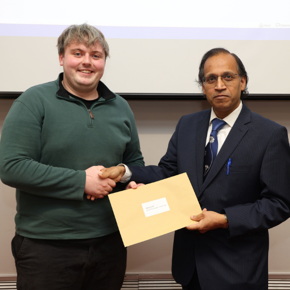 Male student receiving her award from academic