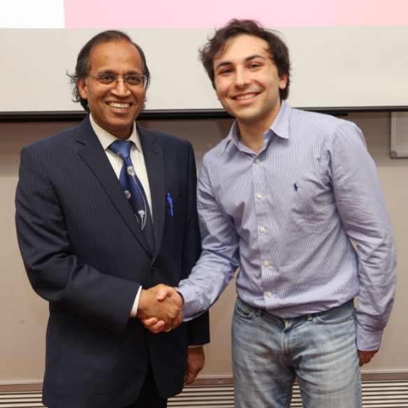 Male student receiving her award from academic
