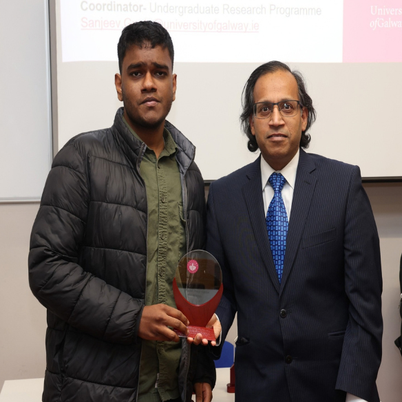 Male student receiving his award from academic