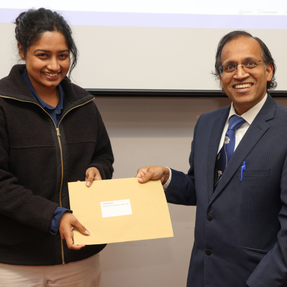 female student receiving her award from academic