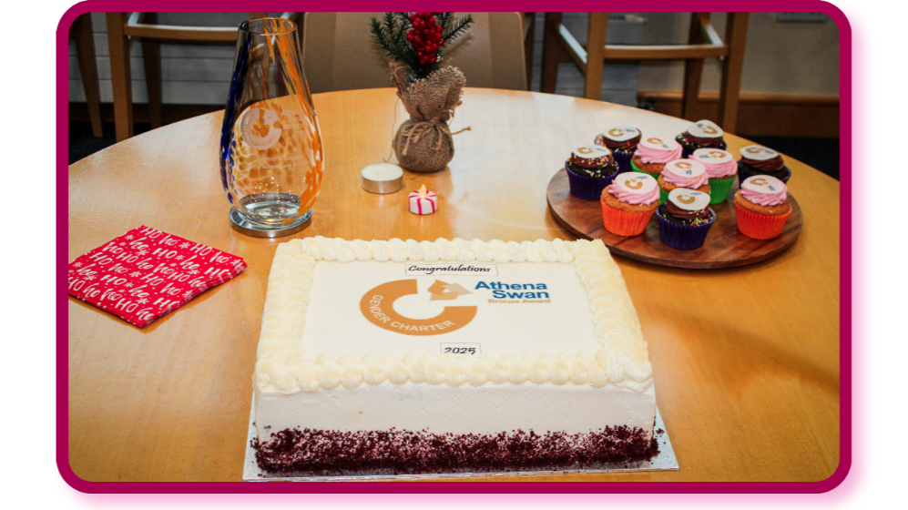 Athena Swan Cake on table with Athena Swan Logo