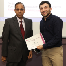 Male student receiving his award from academic