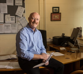 Prof John P Dalton sitting on a desk