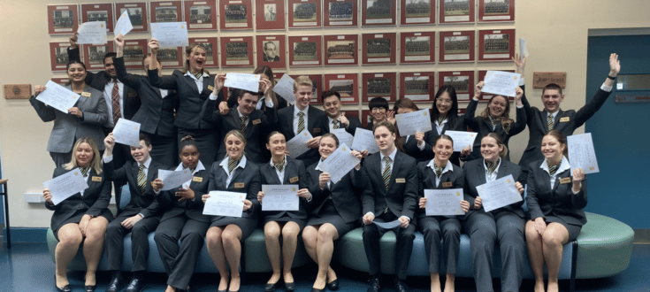 Student ambassadors holding their certificates and smiling
