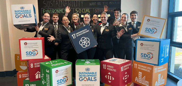 students holding up sustainability buzz words
