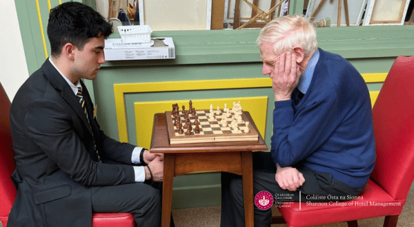 student playing chess with an elderly man