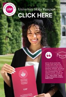 Student in Graduation robes holding a university Skills Passport brochure