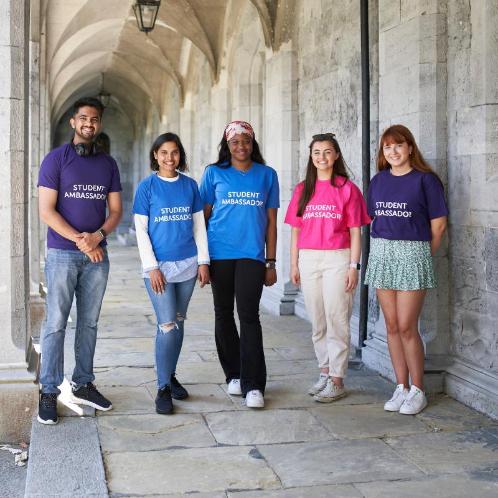 Students standing under the archway at the Quadrangle