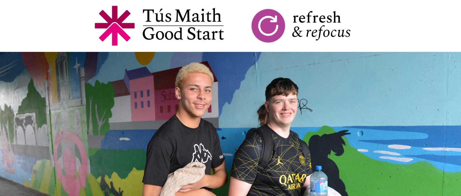 two male students walking past the mural located at the underpass