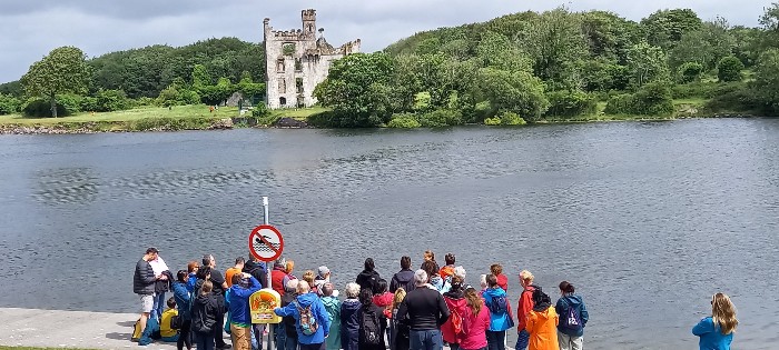people gathered along the river corrib by menlo castle