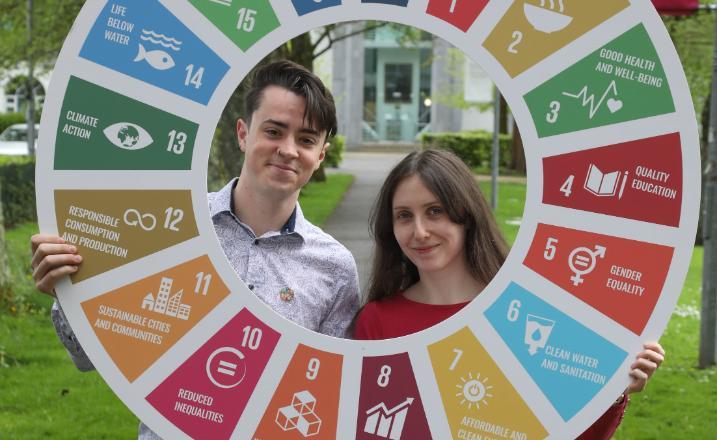 A photo of the two student sustainability interns at the announcement of the University of Galway's receipt of SDG Champion Status for 2023/24.