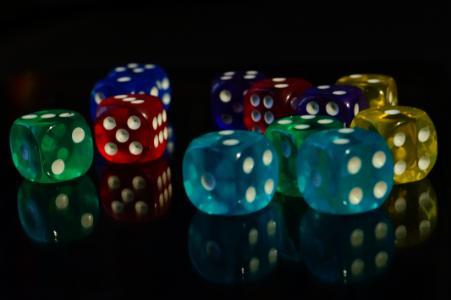 Coloured dice on a black background