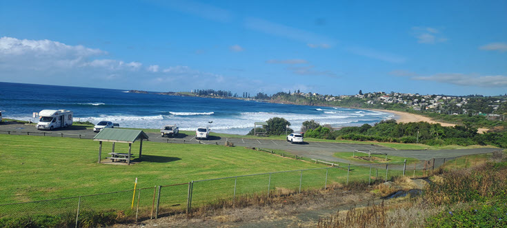 A beach in the distant, blue sky and blue water